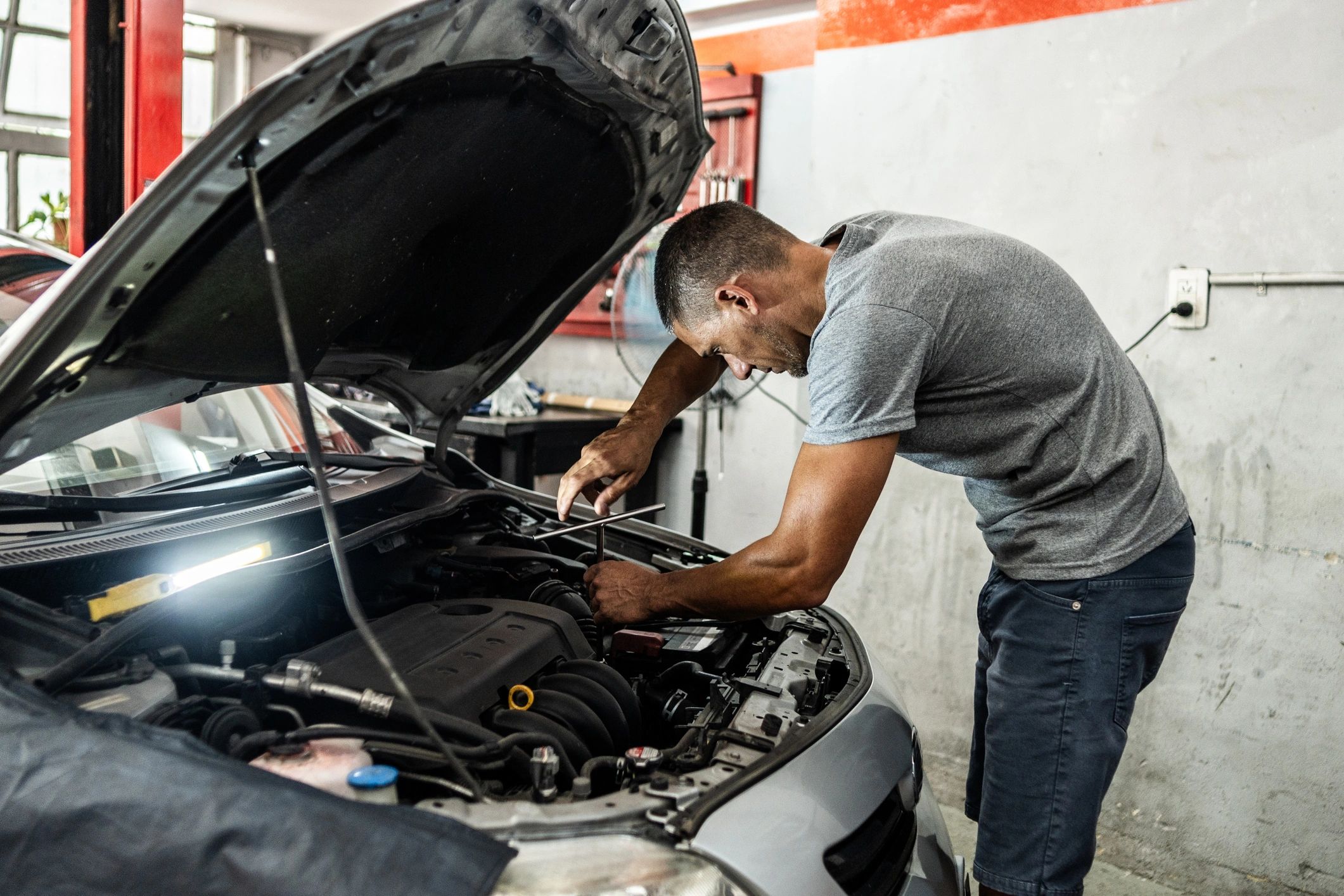 Mechanic working on a vehicle in an auto repair shop